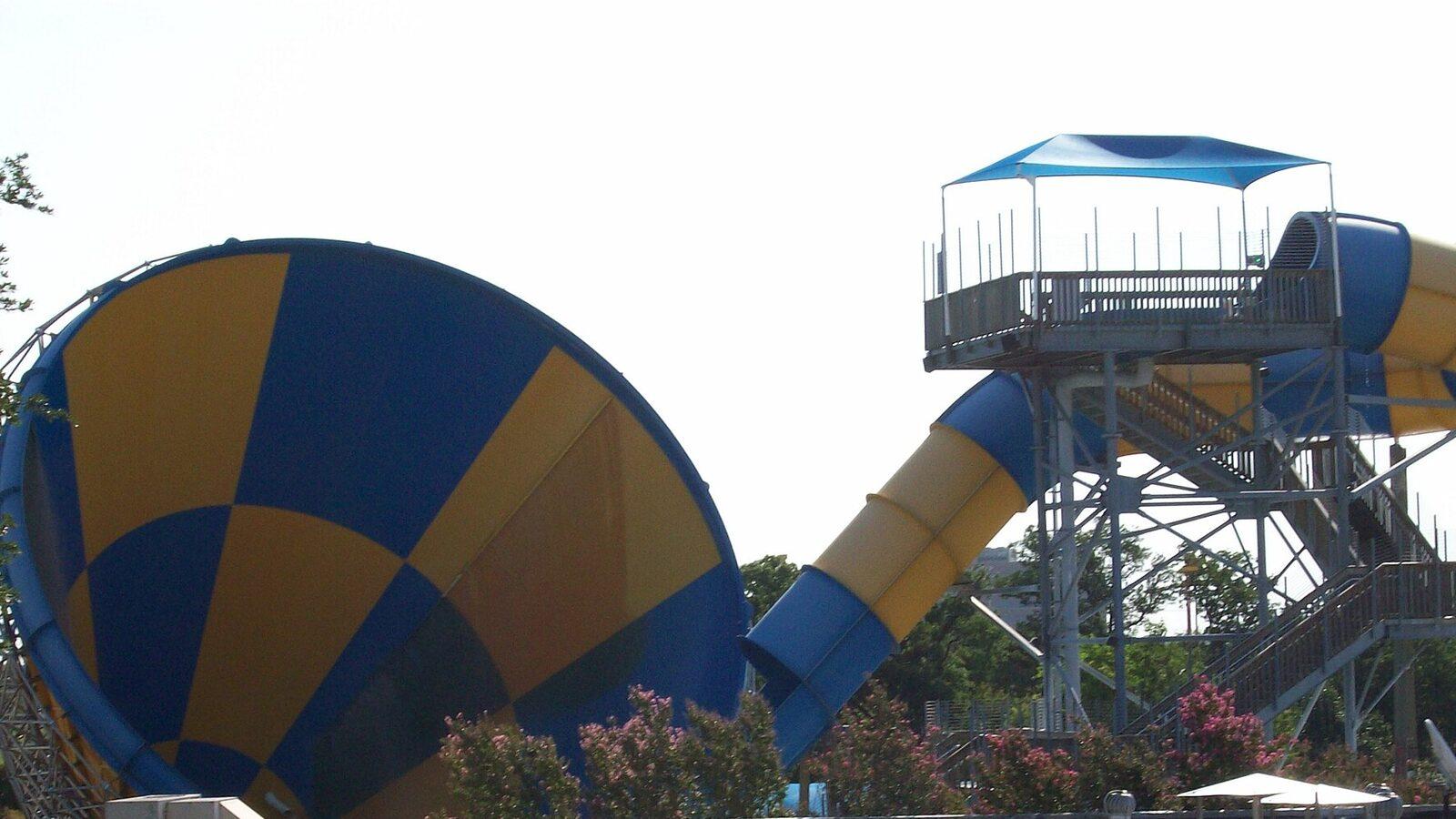 Funnel water slide and tower against a Texas summer sky